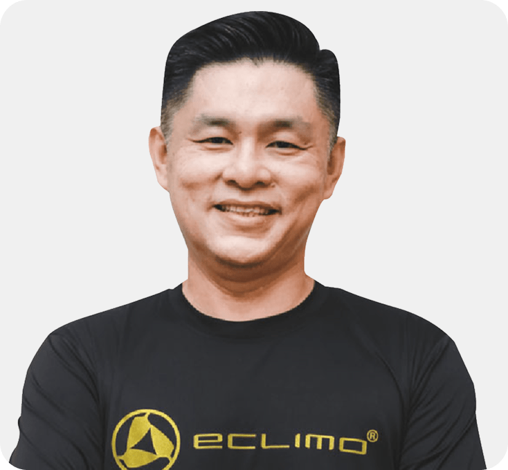 Smiling man in a black shirt with the "Eclimo" logo, short black hair, against a plain white background